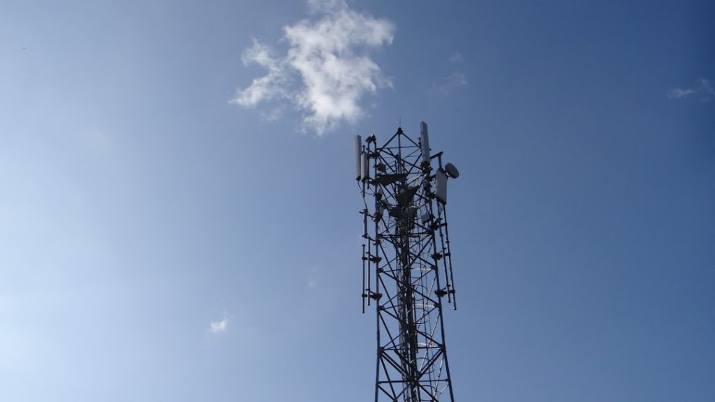 a-cell-phone-tower-is-shown-against-a-blue-sky-wu0wmkepvbs